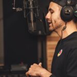Man in Black Crew Neck T-shirt Wearing Black Headphones